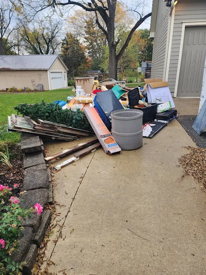 Dumpster being loaded with debris for Estate Cleanout Dumpster Rental in Camden